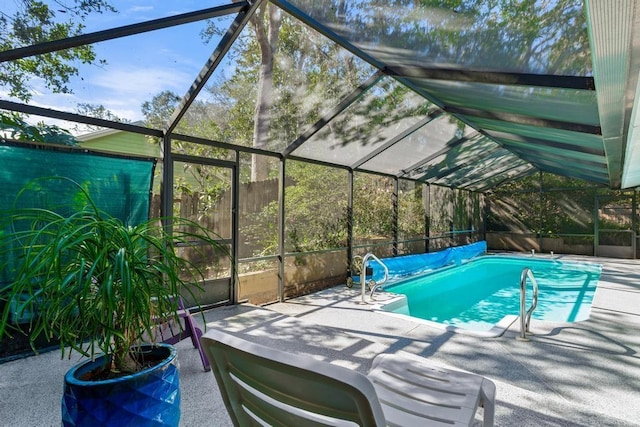 view of swimming pool with a covered pool, a patio, and glass enclosure