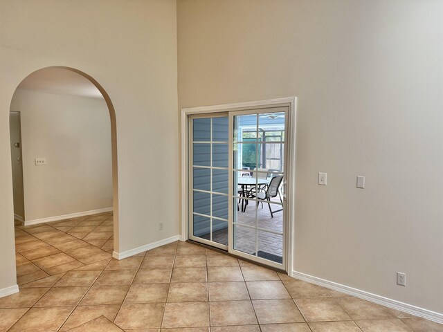 bathroom featuring visible vents, two vanities, a stall shower, tile patterned floors, and a sink