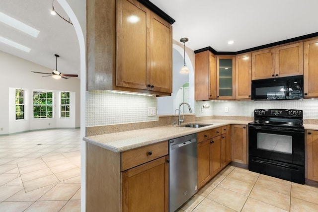 kitchen with light tile patterned floors, a sink, black appliances, glass insert cabinets, and brown cabinets