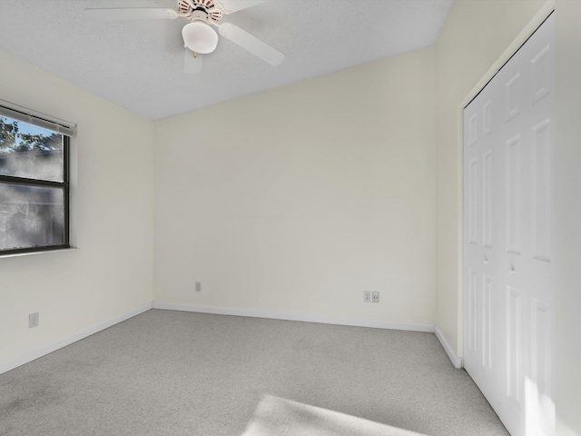 unfurnished bedroom with carpet flooring, ceiling fan, and a closet