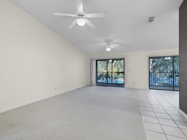 spare room with ceiling fan, light colored carpet, and vaulted ceiling