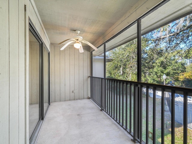 unfurnished sunroom featuring ceiling fan