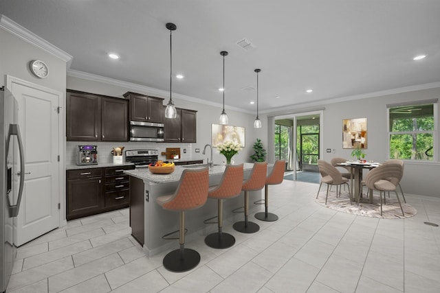 249 La Mancha Dr, Saint Augustine, FL 32086 - kitchen featuring decorative backsplash, visible vents, plenty of natural light, appliances with stainless steel finishes, and a kitchen breakfast bar