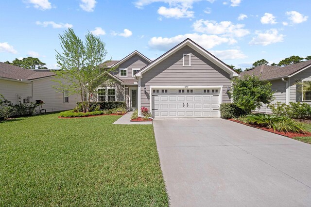 249 La Mancha Dr, Saint Augustine, FL 32086 - view of front of home featuring concrete driveway, an attached garage, and a front lawn