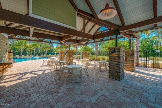 249 La Mancha Dr, Saint Augustine, FL 32086 - view of patio with a community pool and fence