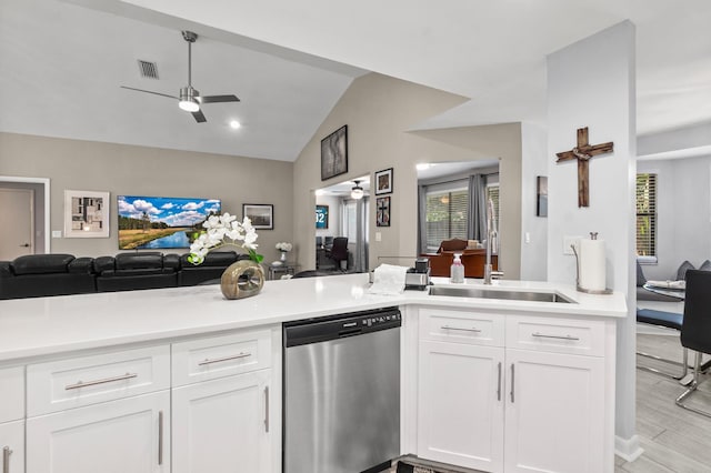 kitchen with dishwasher, ceiling fan, open floor plan, and a sink