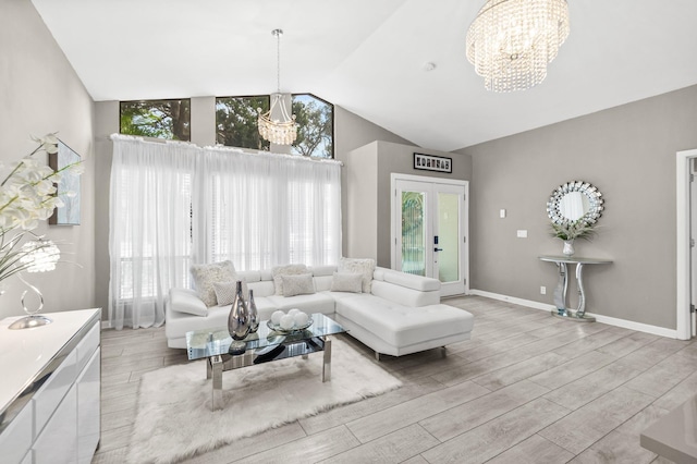 living room featuring baseboards, vaulted ceiling, an inviting chandelier, and wood finished floors