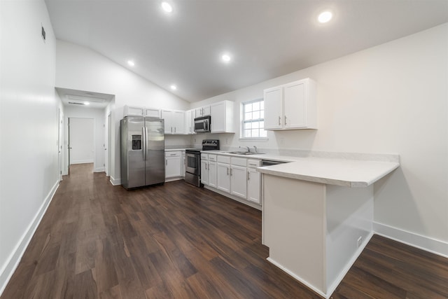 kitchen with stainless steel appliances, dark wood-type flooring, a peninsula, white cabinetry, and light countertops