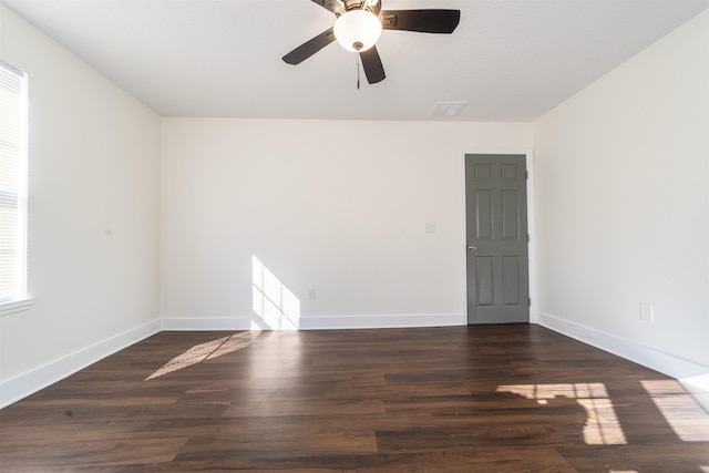 empty room featuring baseboards and wood finished floors