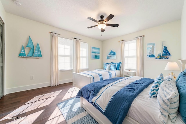 bedroom featuring light wood-type flooring, ceiling fan, and baseboards