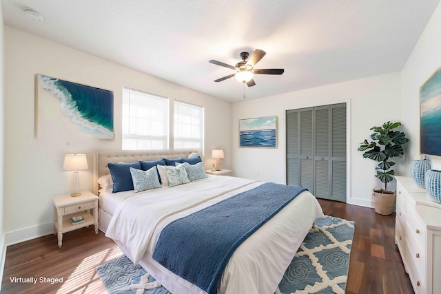 bedroom featuring dark wood-style floors, a closet, and baseboards