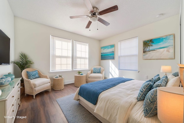 bedroom featuring baseboards, a textured ceiling, a ceiling fan, and wood finished floors