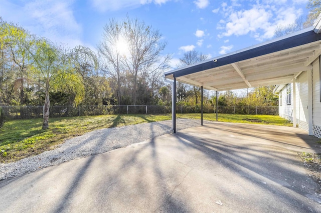 view of patio featuring a carport, a fenced backyard, and concrete driveway