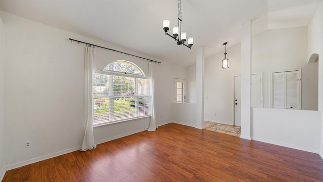 2169 Saint Martins Dr, Jacksonville, FL 32246 - spare room featuring wood finished floors, a chandelier, and high vaulted ceiling