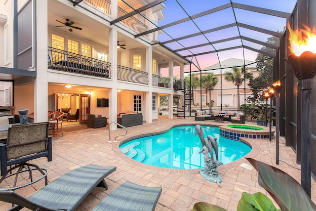 view of pool with a lanai, a patio area, and an outdoor living space