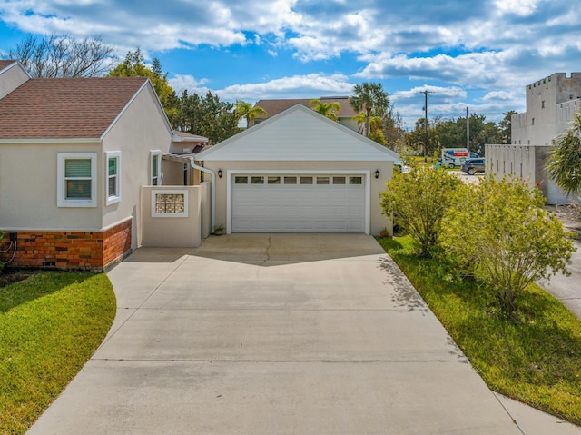 view of front of property with a garage, fence, concrete driveway, and stucco siding