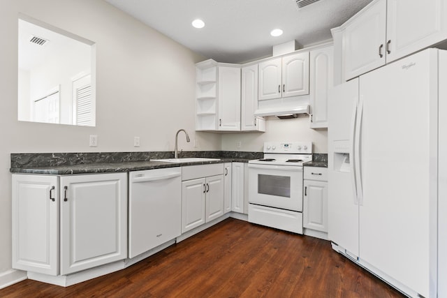 kitchen with extractor fan, white appliances, a sink, visible vents, and dark countertops