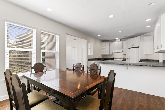 dining room with dark wood-type flooring and recessed lighting