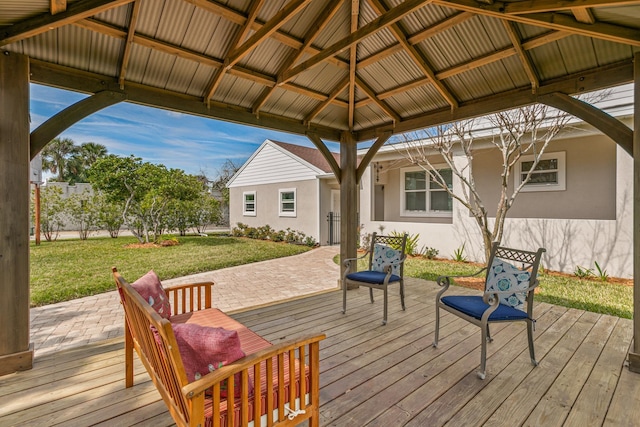 wooden terrace featuring a gazebo and a lawn