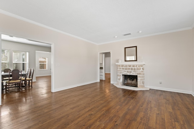 living area featuring baseboards, dark wood-type flooring, a fireplace, and crown molding