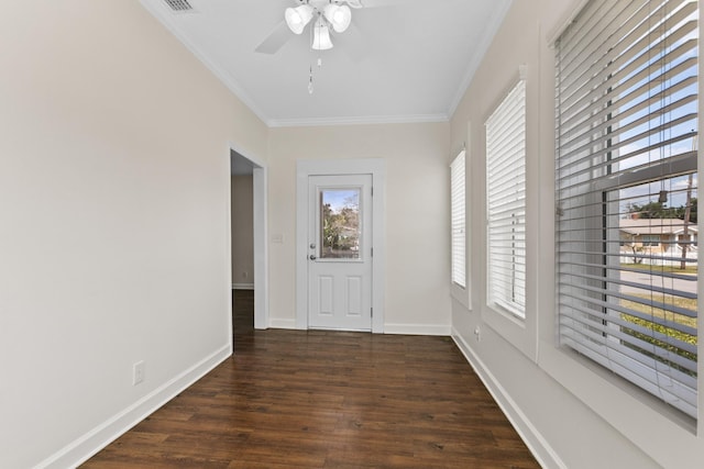 interior space featuring ceiling fan, wood finished floors, visible vents, baseboards, and ornamental molding