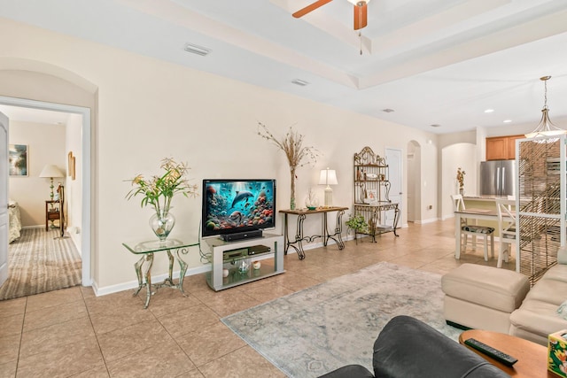 living room with ceiling fan and light tile patterned flooring