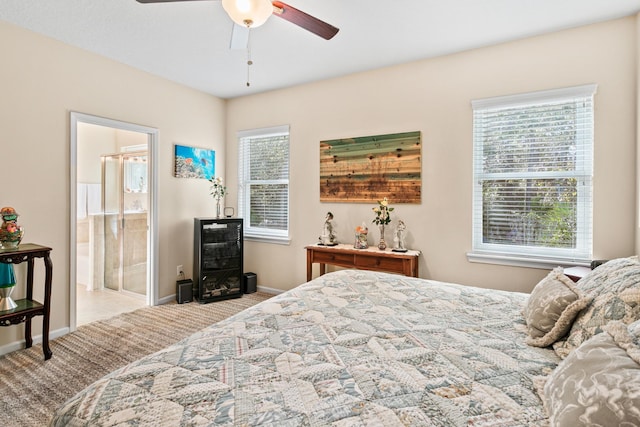 bedroom with connected bathroom, ceiling fan, and light colored carpet