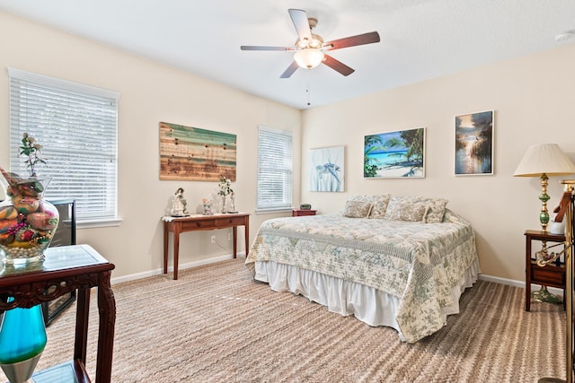 bedroom featuring multiple windows, ceiling fan, and carpet