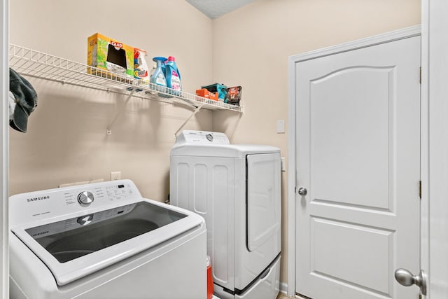 laundry area with washing machine and dryer