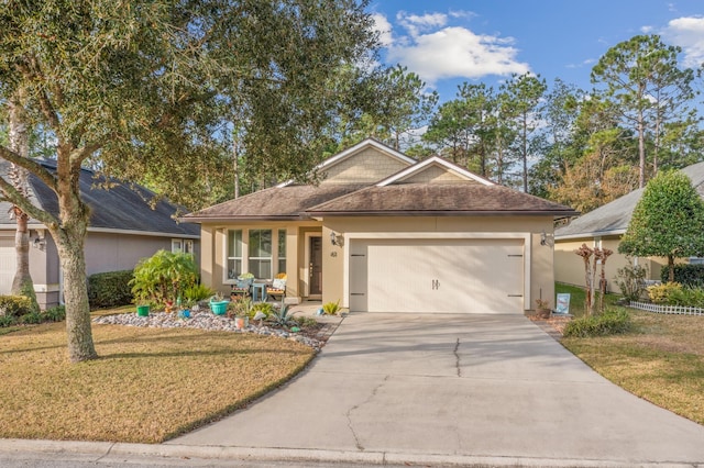 view of front of house with a front yard and a garage