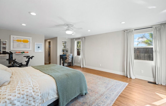 bedroom with a ceiling fan, recessed lighting, baseboards, and wood finished floors