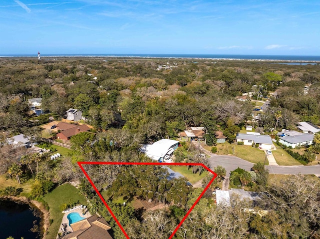 birds eye view of property featuring a view of trees