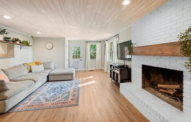 living area featuring light wood-type flooring, wood ceiling, a fireplace, and recessed lighting