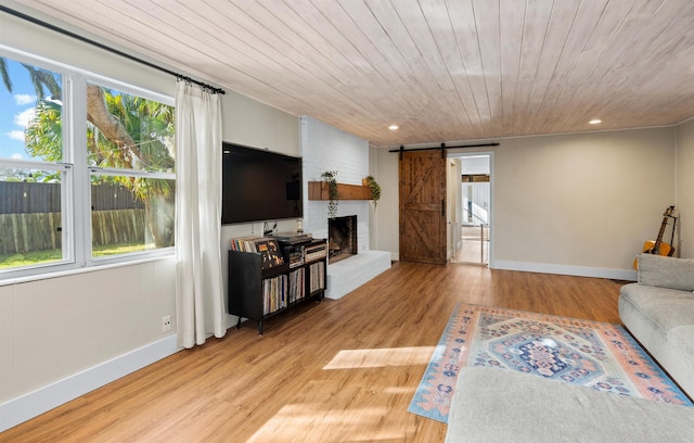 living room with recessed lighting, wooden ceiling, light wood finished floors, and a barn door