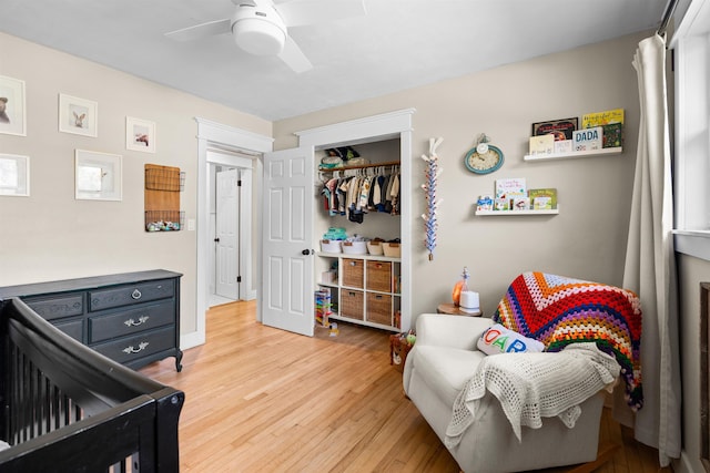 bedroom with a closet, ceiling fan, and light wood finished floors