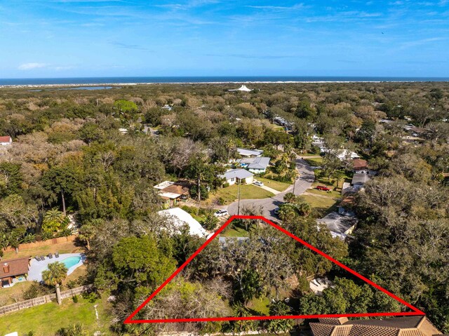 birds eye view of property featuring a wooded view