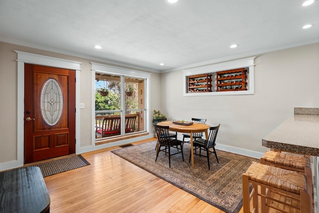 dining space with recessed lighting, wood finished floors, and crown molding