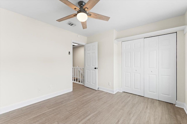 3385 Coastal Hwy Unit 23, Saint Augustine, FL 32084 - unfurnished bedroom featuring wood finished floors, a closet, and a ceiling fan