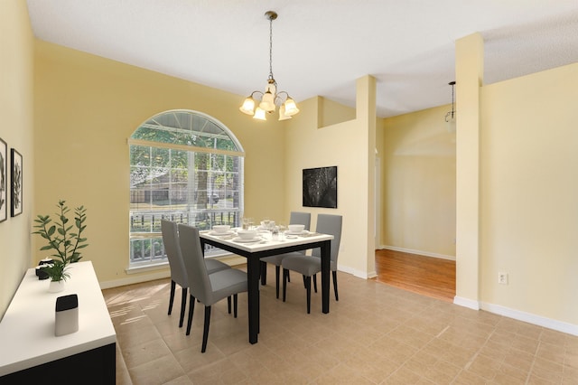 dining area with an inviting chandelier and baseboards