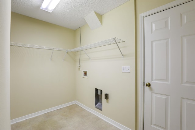 laundry room featuring washer hookup, laundry area, baseboards, and a textured ceiling