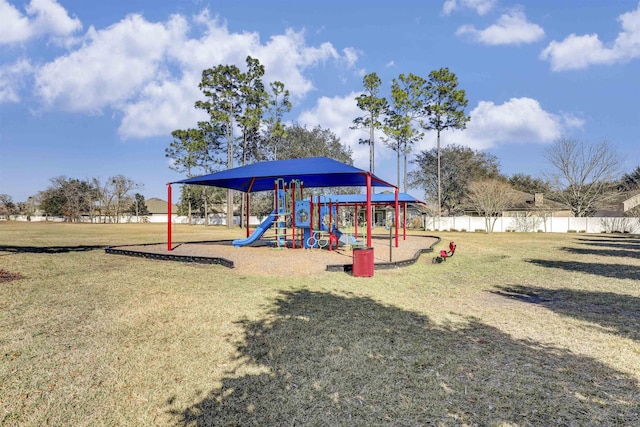 community playground featuring fence and a lawn