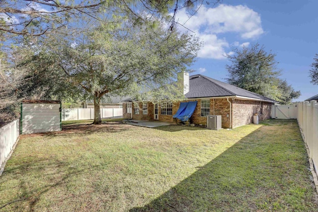 view of yard with a patio, central AC unit, and a fenced backyard