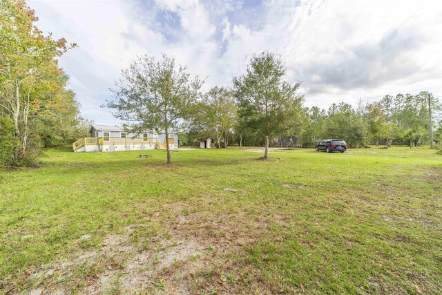 9610 Ebert Ave, Hastings, FL 32145 - view of green lawn with a deck