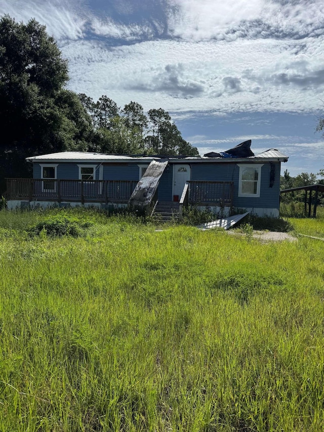 9610 Ebert Ave, Hastings, FL 32145 - view of front of home with a deck and a metal roof