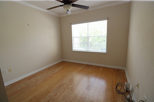 unfurnished room featuring crown molding, ceiling fan, light wood finished floors, and baseboards