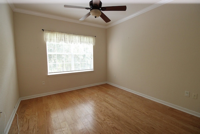 empty room featuring light wood-style flooring, baseboards, crown molding, and a ceiling fan