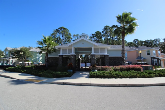 view of front facade with a gate and stucco siding