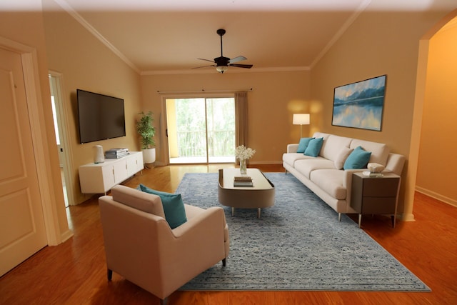living area with arched walkways, wood finished floors, ornamental molding, and a ceiling fan