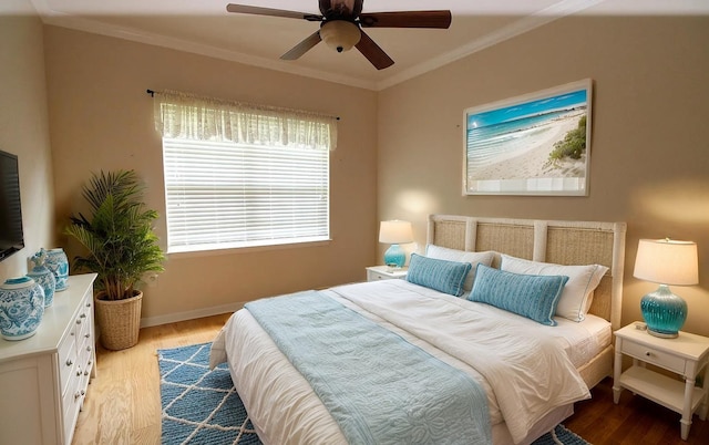 bedroom featuring ornamental molding, baseboards, ceiling fan, and wood finished floors