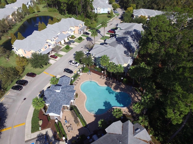 drone / aerial view with a residential view and a water view